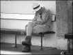 Older man dozing on bench at Exeter Bus station P1130914.JPG
