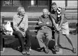 Three men on bench outside Sidmouth Market TZ70 P1030382.JPG