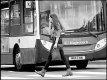 Young woman on phone crossing in front of bus Exeter P1011092.JPG