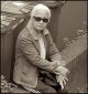 Older woman sitting on wall Heavitree Road Exeter DSC01496.JPG