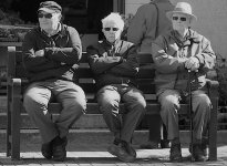 Three men sitting on bench outside Sidmouth market P3250009.JPG