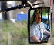 Bus driver in his mirror Panasonic TZ40 1010957.jpg