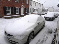 Snow covered cars in street DSC01311.JPG