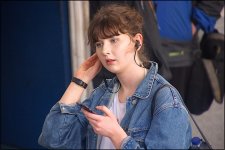 Young woman listening to smart phone earplugs DSC00717.JPG