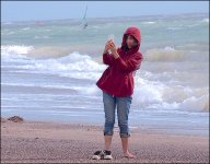 Anorak girl taking picture with phone Exmouth beach E-PL5 P9240027.jpg