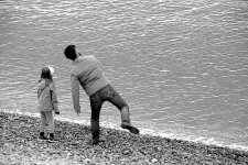Father throwing stone out to sea while daughter watches Sidmouth IMG_3112.JPG