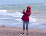 Anorak girl taking picture with phone Exmouth beach E-PL5 P9240027.jpg